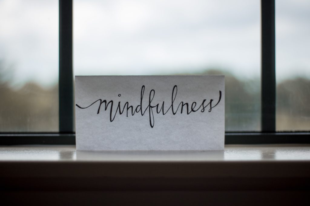 Mindfulness sign in front of a window